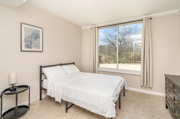 a bedroom with a bed and a window