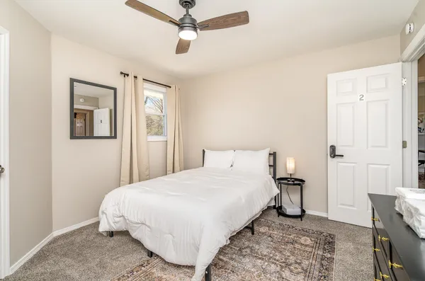 a bedroom with a bed and a window