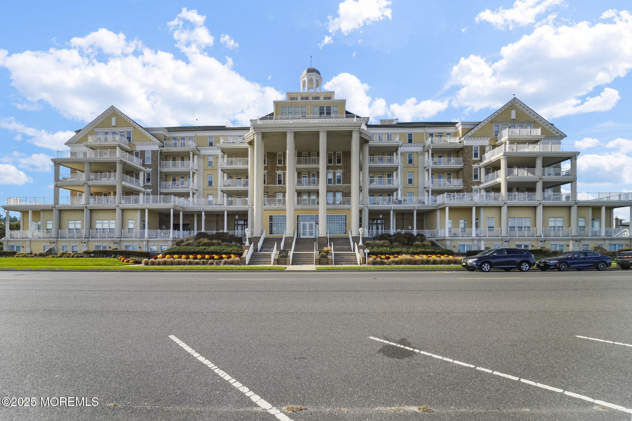 a front view of a building with street view and lake view