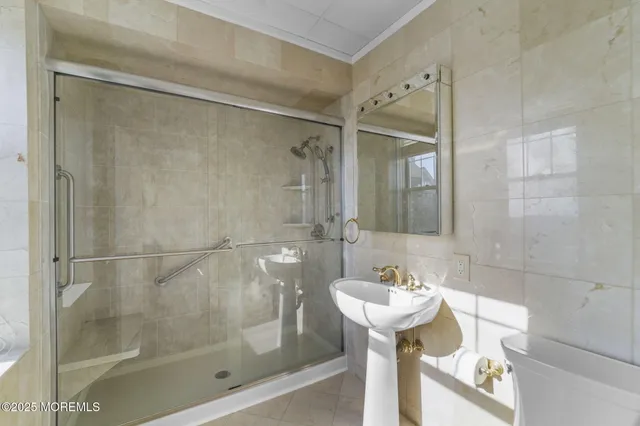 a bathroom with a shower and a sink