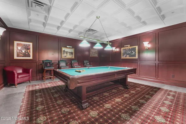 a room with pool table and windows