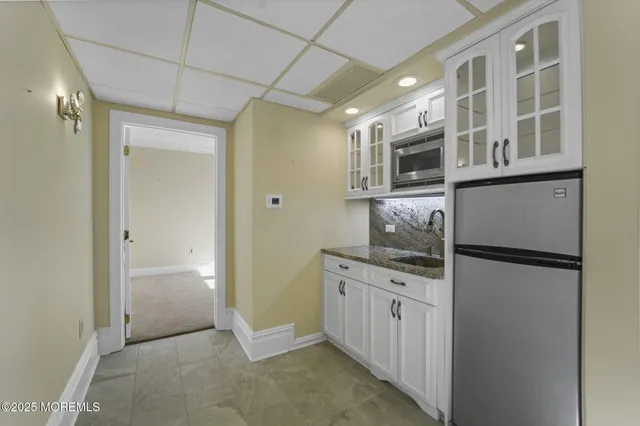 a kitchen with a refrigerator a stove a microwave and cabinets