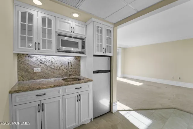 a kitchen with stainless steel appliances granite countertop a refrigerator and a stove