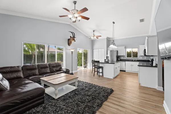 a living room with furniture and kitchen view