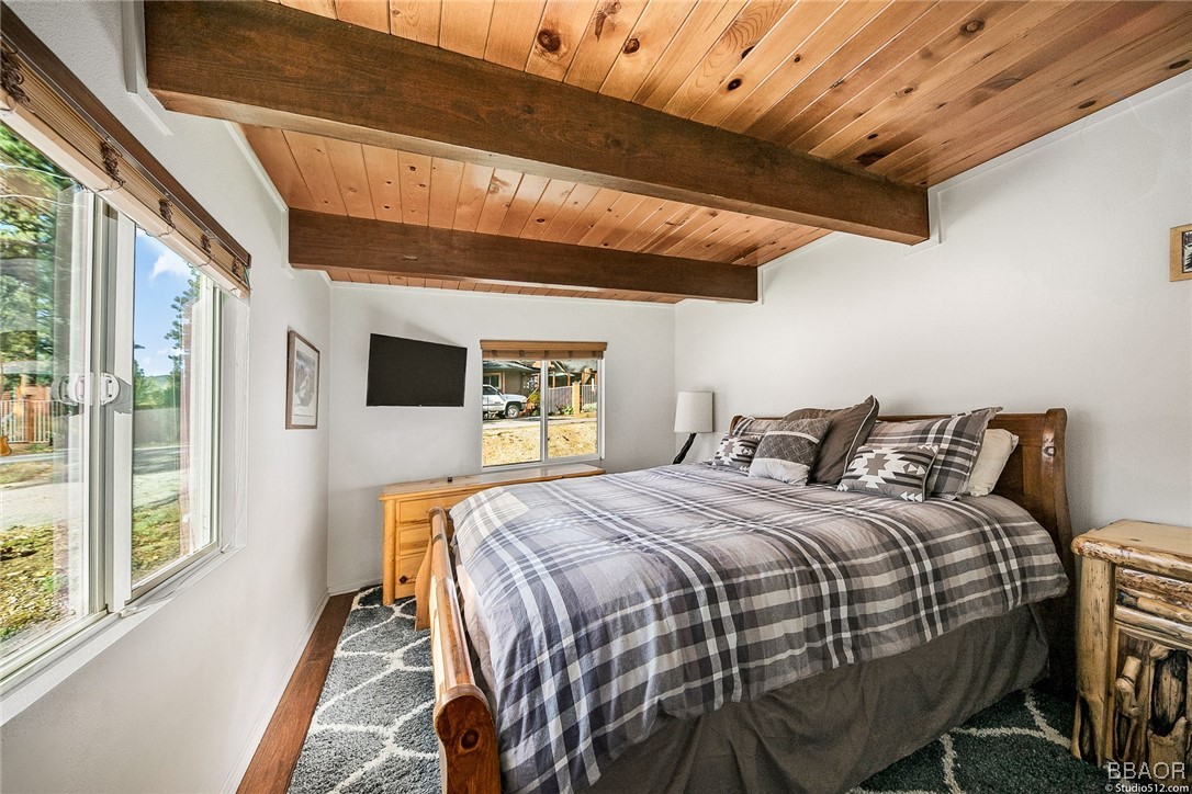 308 Eagle Drive Big Bear Lake, CA 92315 - Photo 12 of 29 a bedroom with a bed next to a large window with the outer view