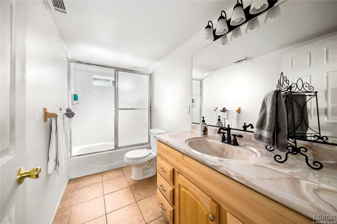 308 Eagle Drive Big Bear Lake, CA 92315 - Photo 15 of 29 a bathroom with a sink a toilet and a mirror