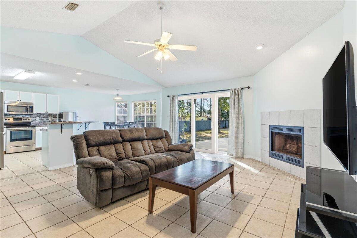 7095 Jasper Street Navarre, FL 32566 - Photo 1 of 26 a living room with furniture and a fireplace