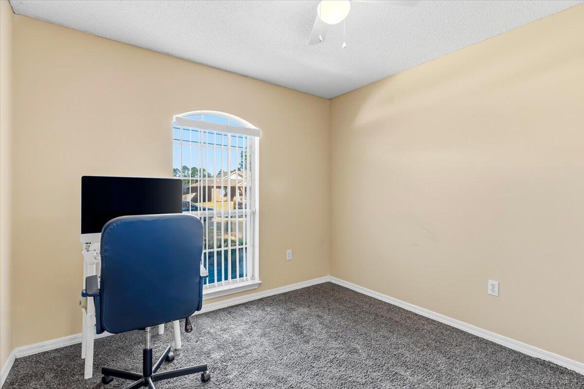 7095 Jasper Street Navarre, FL 32566 - Photo 15 of 26 a workspace with furniture and a window