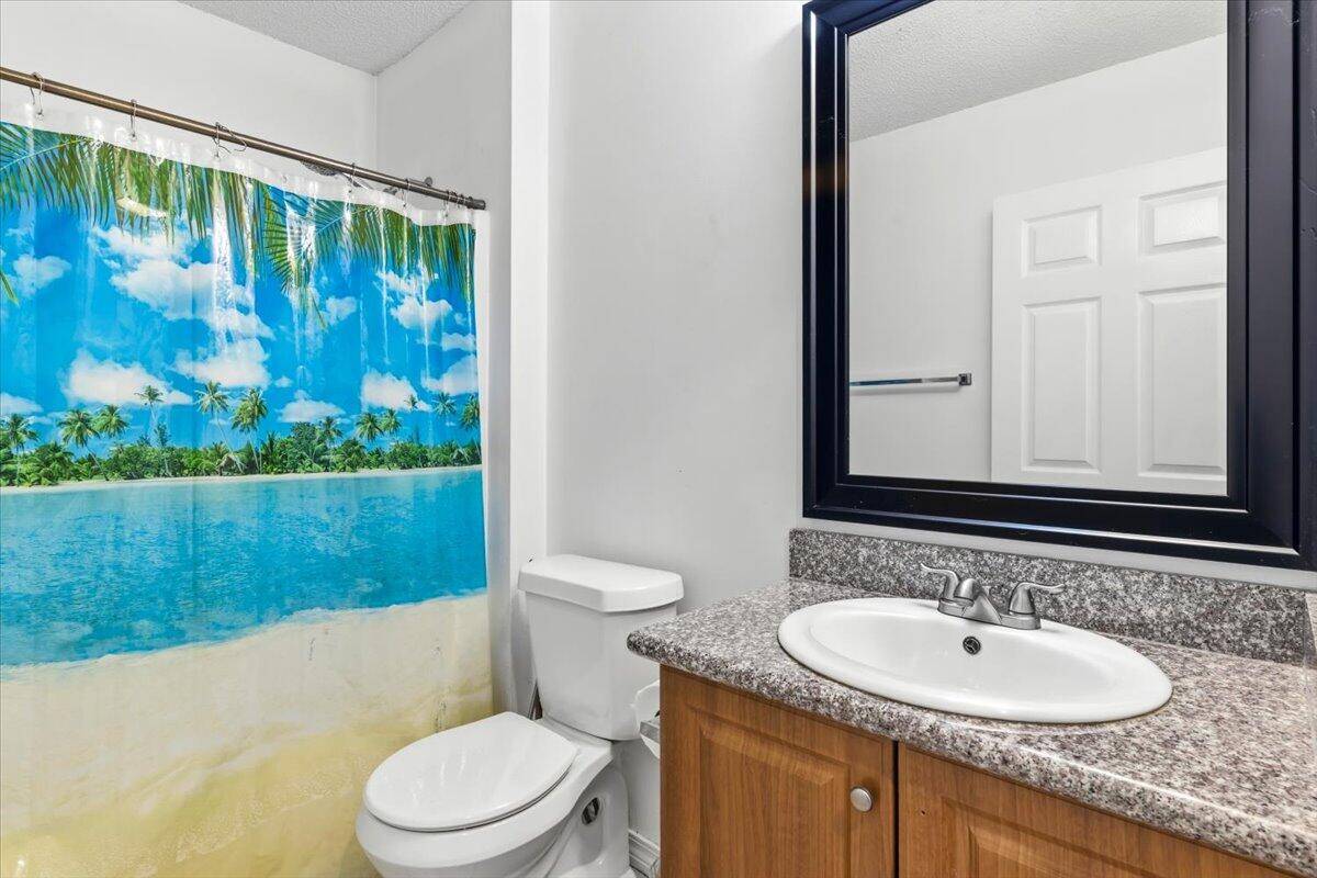 7095 Jasper Street Navarre, FL 32566 - Photo 20 of 26 a bathroom with a sink and a toilet