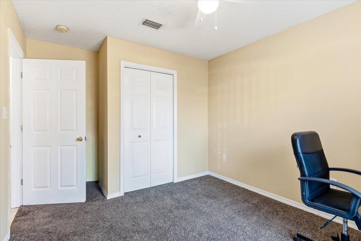 7095 Jasper Street Navarre, FL 32566 - Photo 22 of 26 a view of workspace with furniture and wooden floor