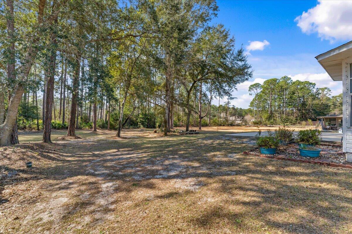 7095 Jasper Street Navarre, FL 32566 - Photo 24 of 26 a view of a outdoor space with trees