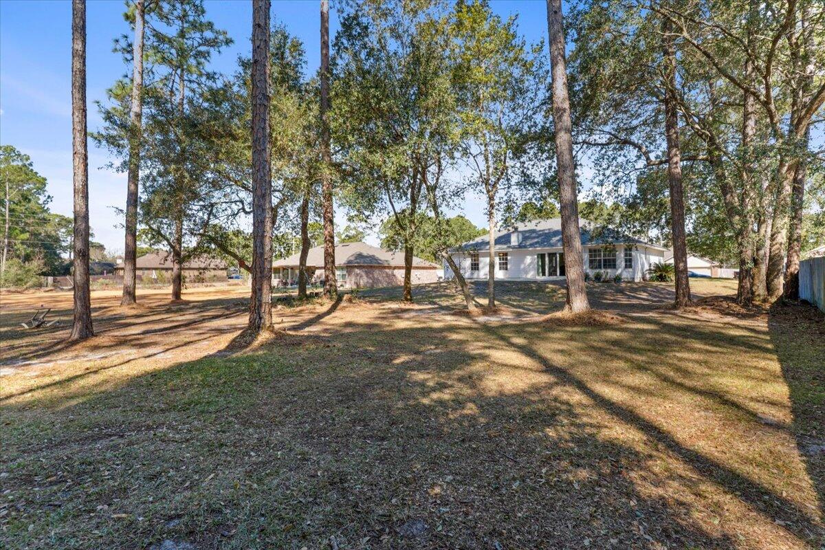7095 Jasper Street Navarre, FL 32566 - Photo 25 of 26 a view of road with trees