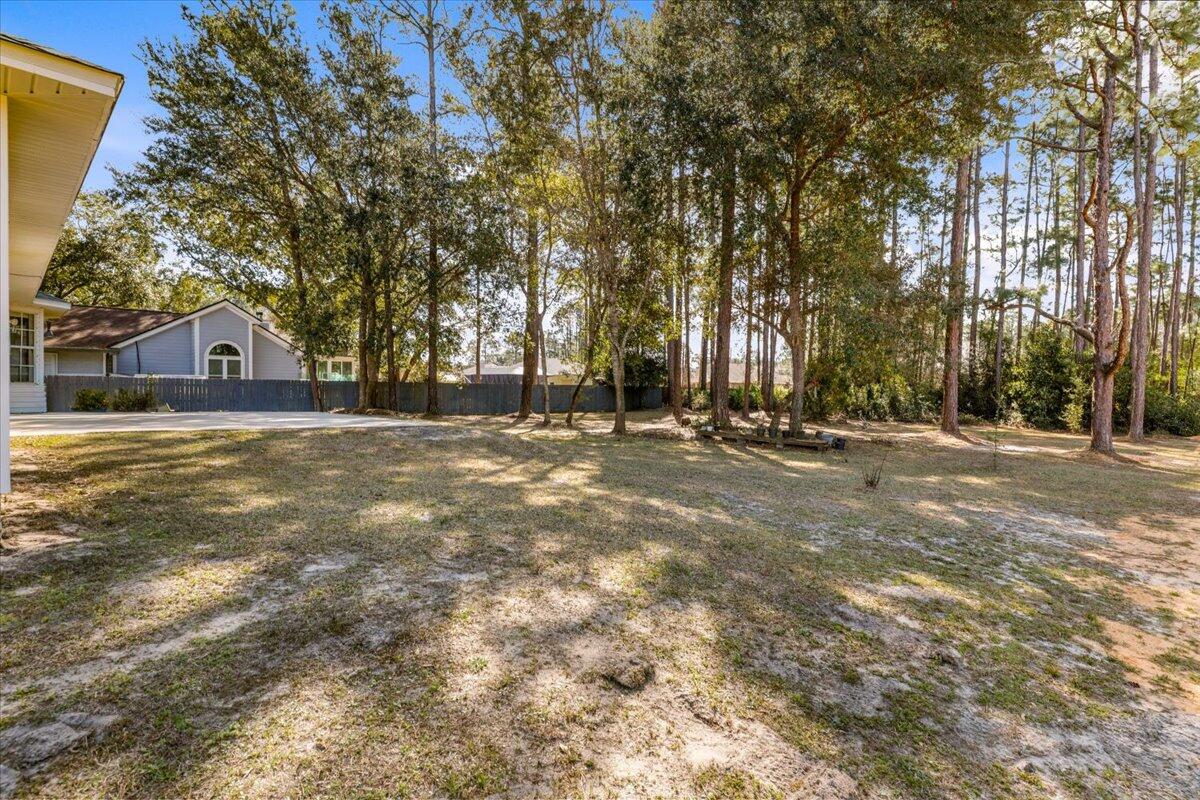 7095 Jasper Street Navarre, FL 32566 - Photo 26 of 26 a view of swimming pool with trees