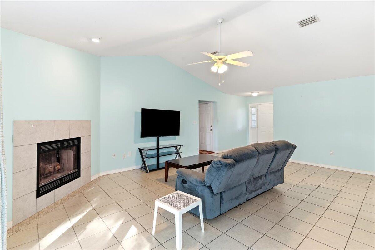7095 Jasper Street Navarre, FL 32566 - Photo 4 of 26 a living room with furniture and a fireplace