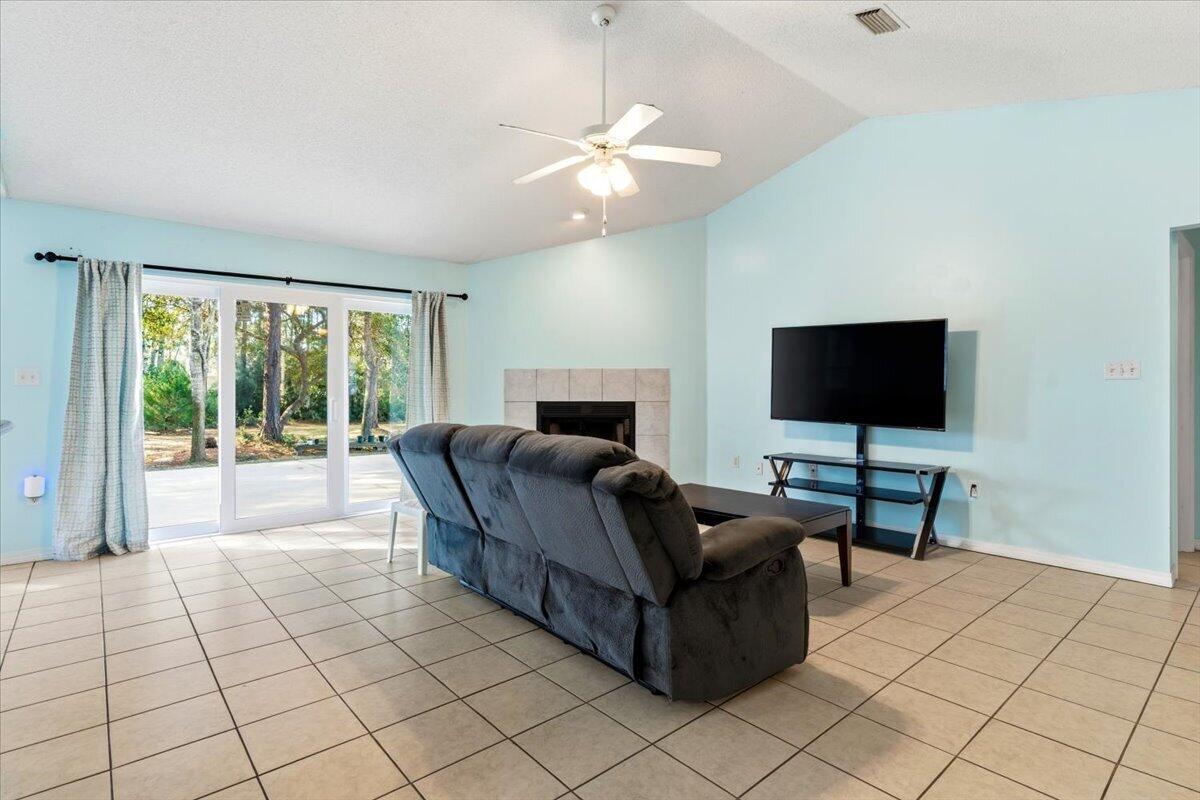 7095 Jasper Street Navarre, FL 32566 - Photo 5 of 26 a living room with furniture and a flat screen tv
