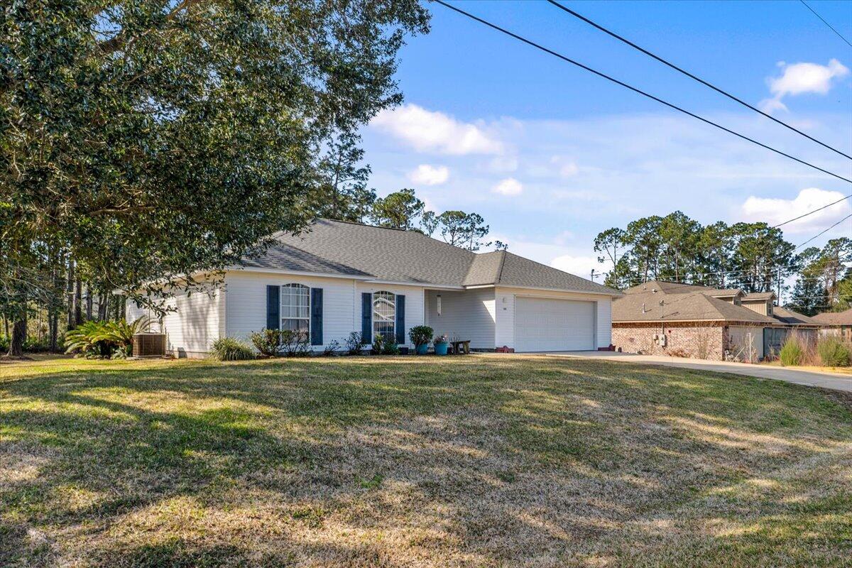 7095 Jasper Street Navarre, FL 32566 - Photo 7 of 26 a house view with a garden space