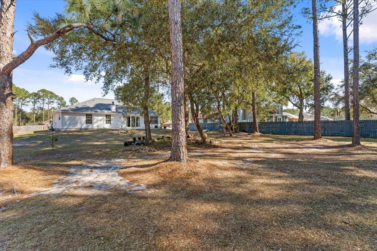 7095 Jasper Street Navarre, FL 32566 - Photo 10 of 26 a view of road with large trees