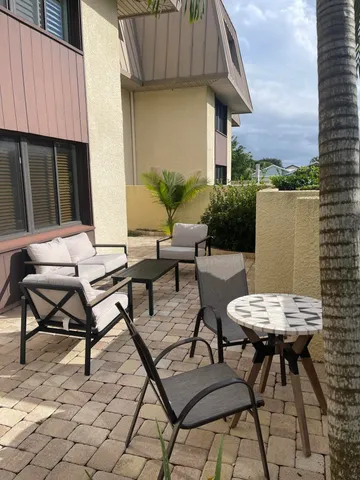 a view of a room with furniture and large windows