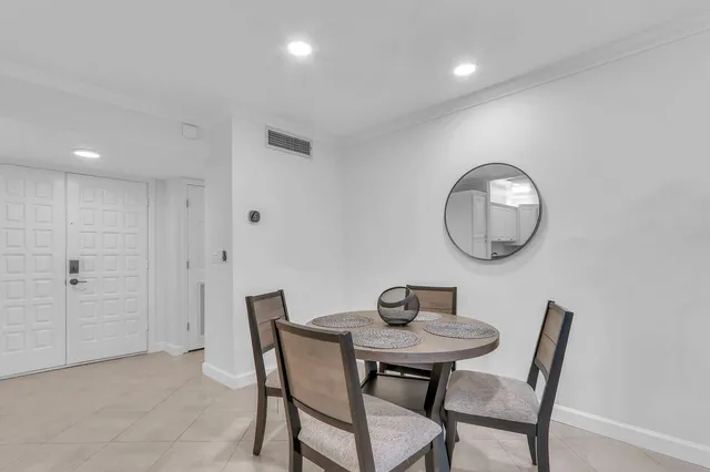 a kitchen with stainless steel appliances granite countertop a sink a stove a refrigerator and island