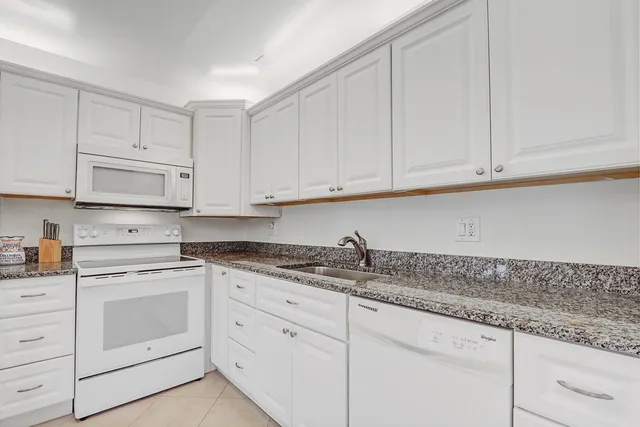 a kitchen with a table and chairs in it