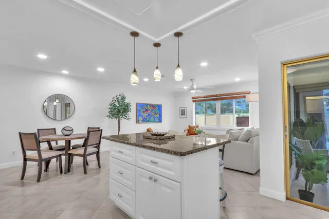 a kitchen with white cabinets and stove
