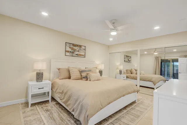 a spacious bedroom with a bed and a walk in closet