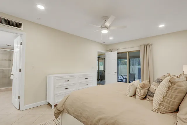 a bathroom with a granite countertop sink toilet a mirror and shower