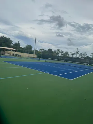 a view of an outdoor space and tennis court