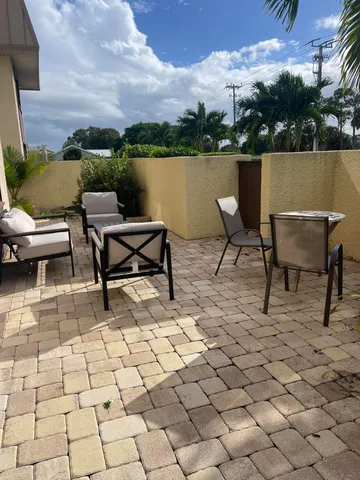 a view of a patio with couple of chairs
