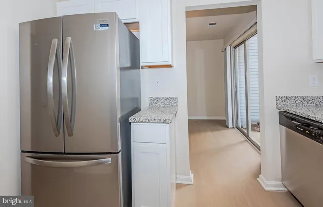a kitchen with a refrigerator and a stove