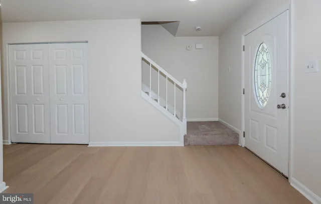 a view of an entryway with wooden floor
