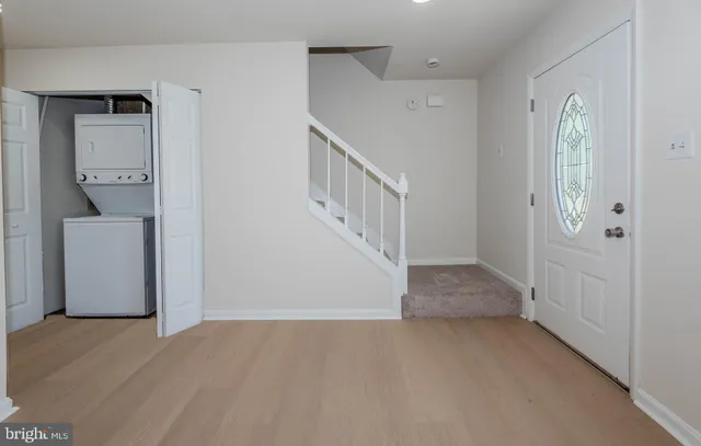 a view of hallway with stairs and a livingroom