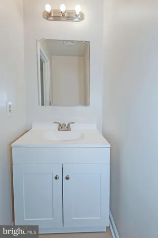 a bathroom with a sink vanity and a mirror