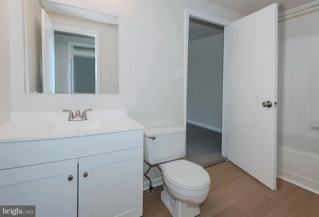 a bathroom with a sink toilet and vanity