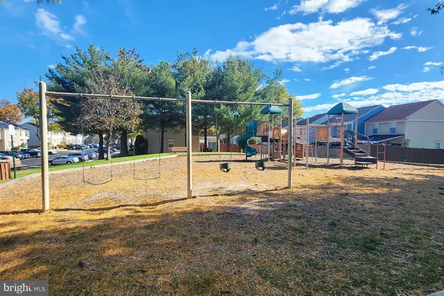 a view of a park with swings and slides