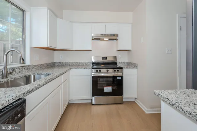 a kitchen with stainless steel appliances granite countertop a stove and a sink