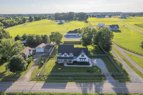 an aerial view of ocean and residential houses with outdoor space