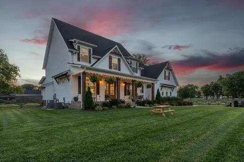 a view of a house with a yard and a garden