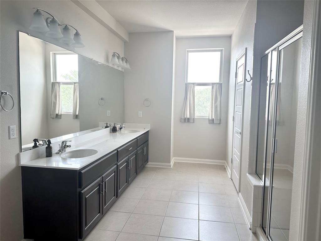 6814 East Riverside Drive, Unit 26 Austin, TX 78741 - Photo 10 of 21 Long vanity with dual sinks provides ample space in this well-lit bathroom.