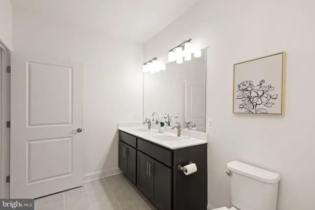 a bathroom with a sink mirror and toilet