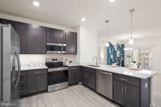 a kitchen with a sink a stove and cabinets