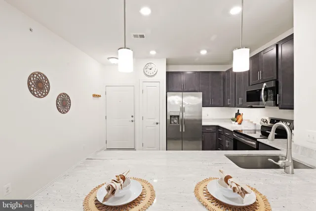 a kitchen with a refrigerator a sink and a wooden cabinets