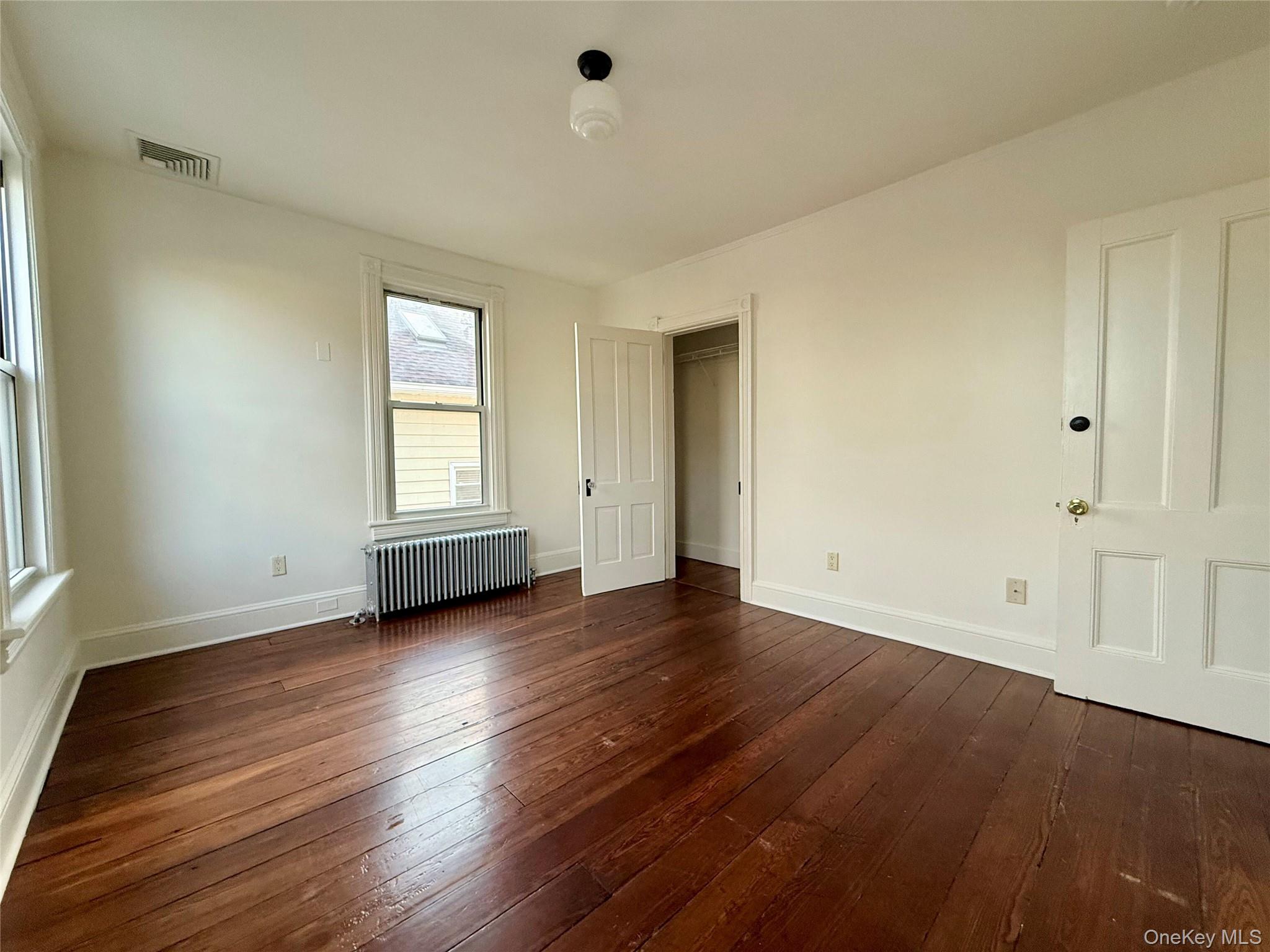 102 North Midland Avenue, Unit 2 Nyack, NY 10960 - Photo 11 of 19 an empty room with wooden floor and windows