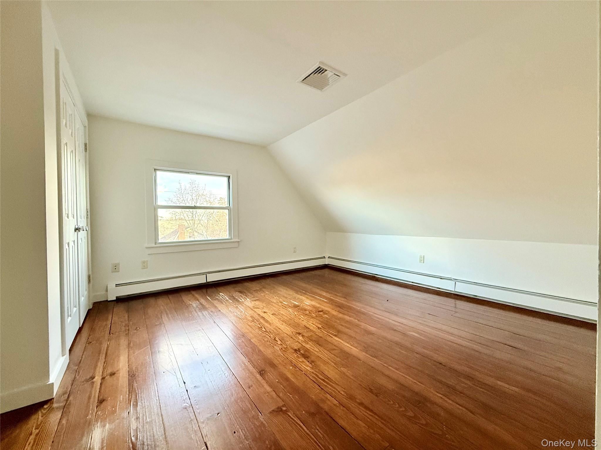 102 North Midland Avenue, Unit 2 Nyack, NY 10960 - Photo 13 of 19 an empty room with wooden floor and windows