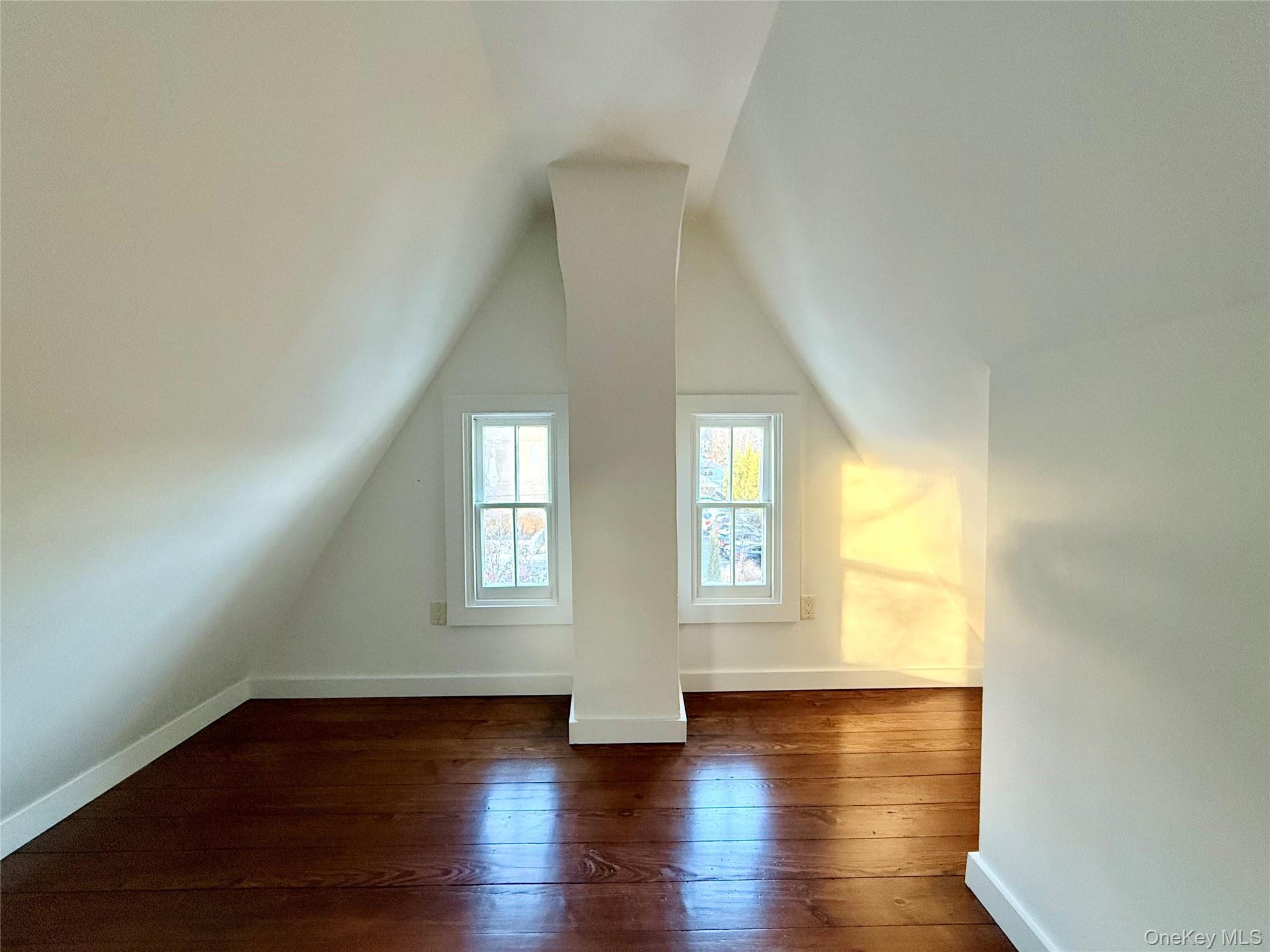 102 North Midland Avenue, Unit 2 Nyack, NY 10960 - Photo 16 of 19 an empty room with wooden floor and windows