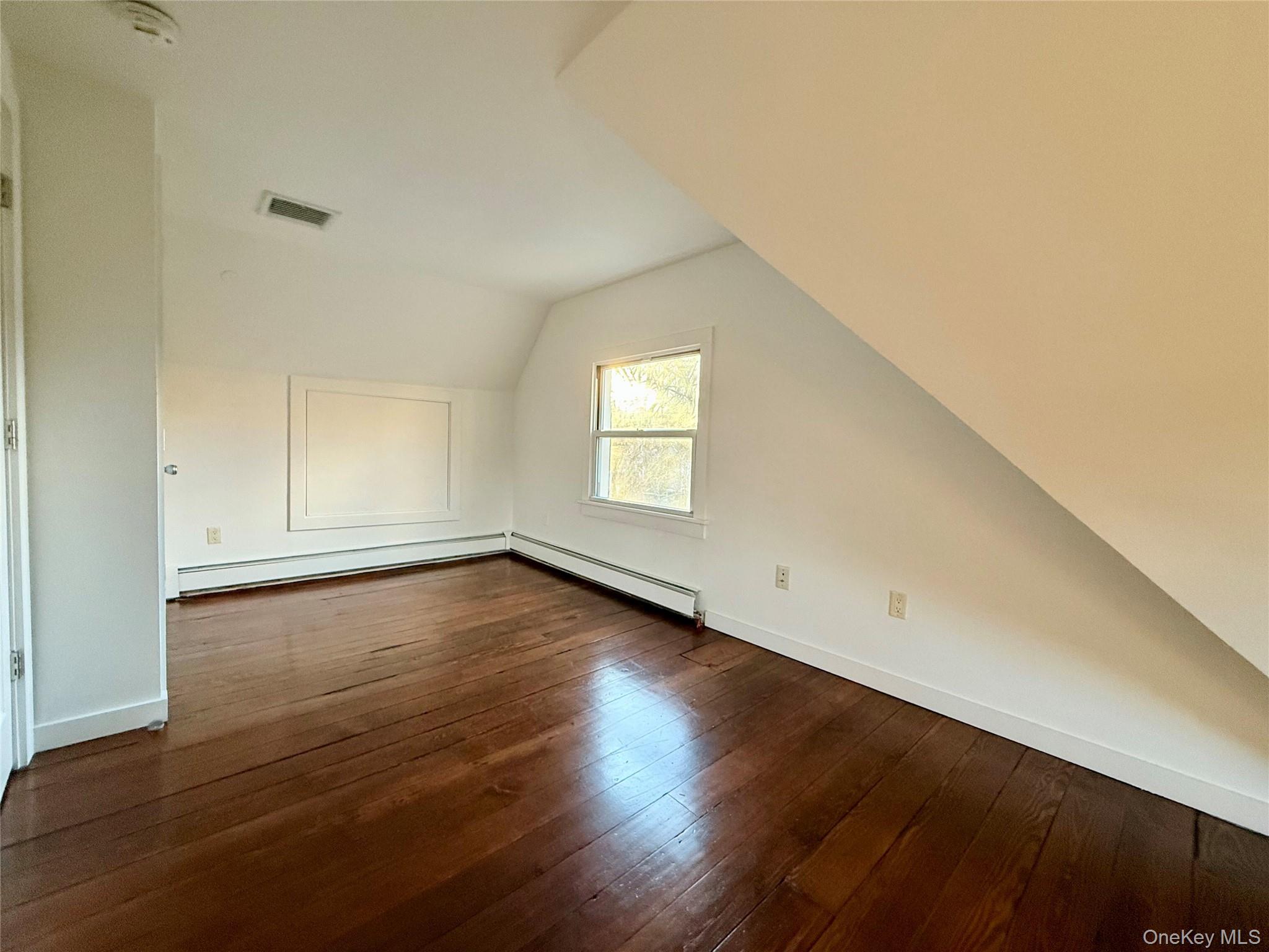 102 North Midland Avenue, Unit 2 Nyack, NY 10960 - Photo 17 of 19 an empty room with wooden floor and windows