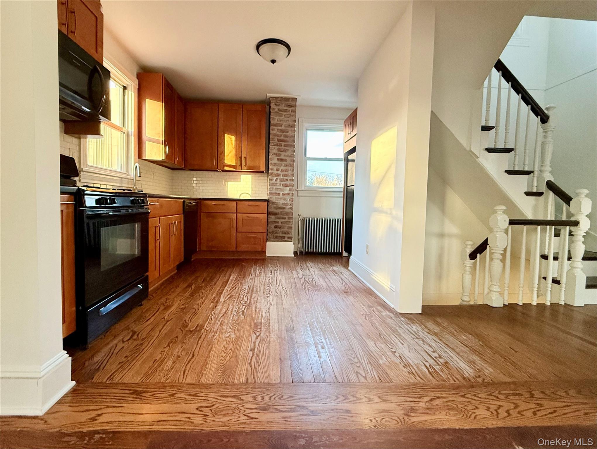 102 North Midland Avenue, Unit 2 Nyack, NY 10960 - Photo 4 of 19 a kitchen with granite countertop a stove and a wooden floors