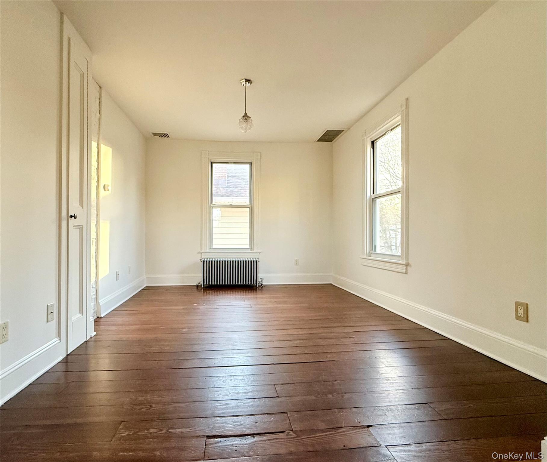 102 North Midland Avenue, Unit 2 Nyack, NY 10960 - Photo 5 of 19 an empty room with wooden floor and windows