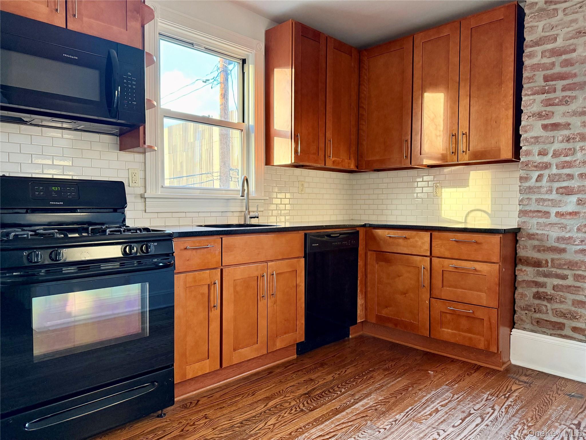 102 North Midland Avenue, Unit 2 Nyack, NY 10960 - Photo 7 of 19 a kitchen with stainless steel appliances granite countertop wooden cabinets a stove top oven a sink and dishwasher