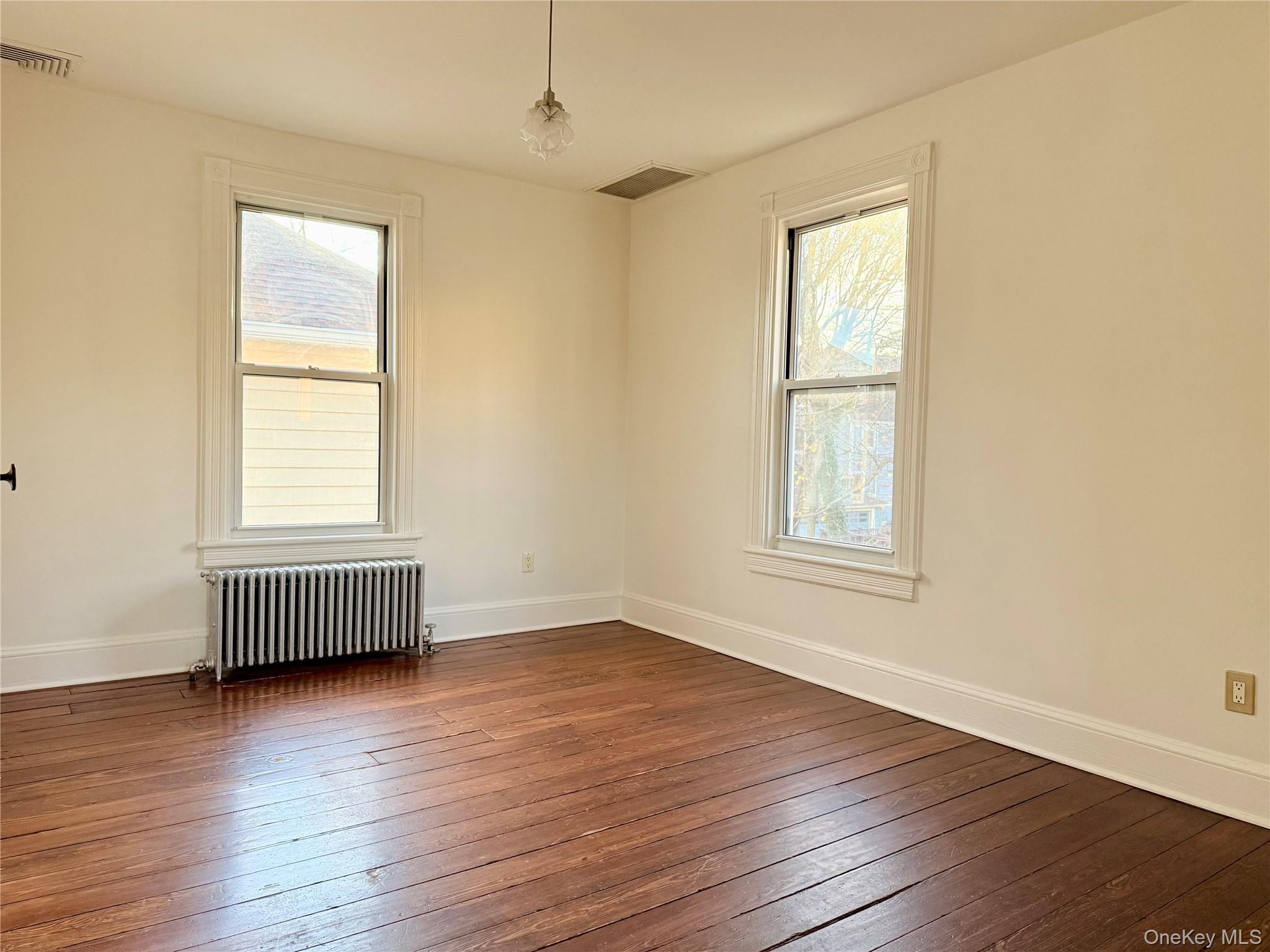 102 North Midland Avenue, Unit 2 Nyack, NY 10960 - Photo 8 of 19 an empty room with wooden floor and windows
